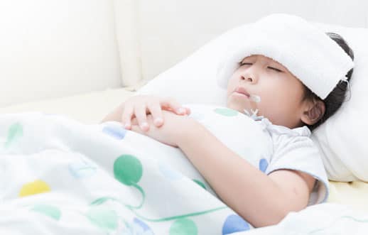 Child With Fever Has Towel On Her Forehead