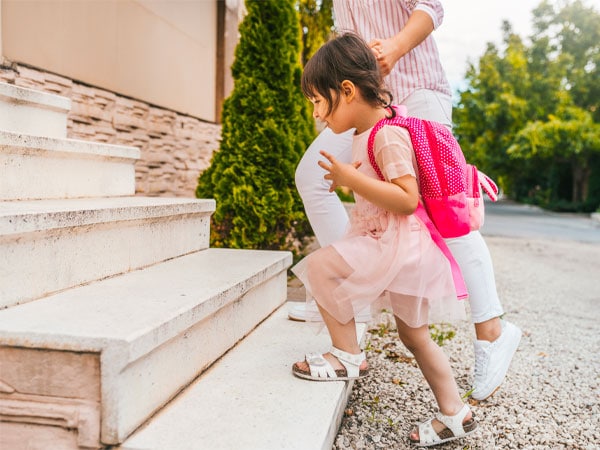 Child Holding Hands With Mother At School