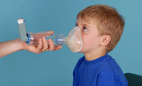 A child with asthma is given a nebulizer to help with breathing