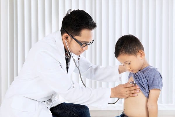 Doctor Performing Health Check on Child