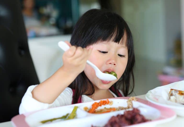 Girl Eating Vegetables