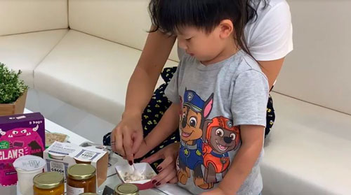 A mother and her son prepares healthy snacks while on vacation overseas