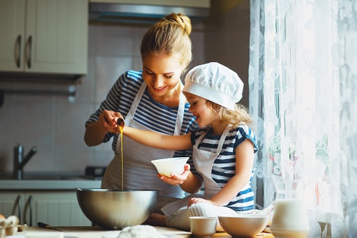 Mother and Daughter Preparing Meal in Kitchen