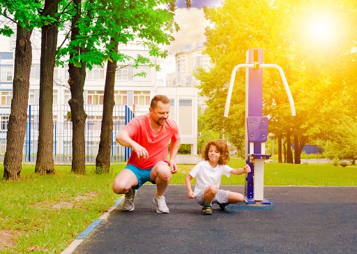 Father and Son Exercising in Park