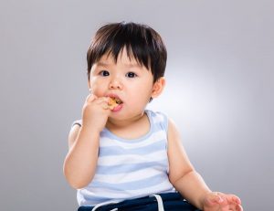 Baby Eating And Chewing Snacks