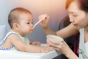 Mother Feeding The Baby