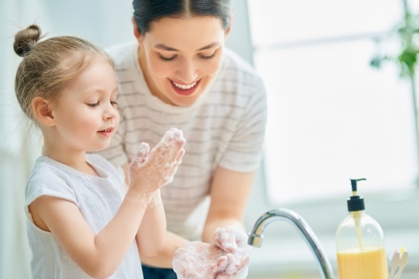 Mother And Daughter Washing Hands