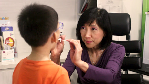 Dr Heng Siok Kheng Checking Boy's Oral Health