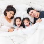 A happy family lying on the bed
