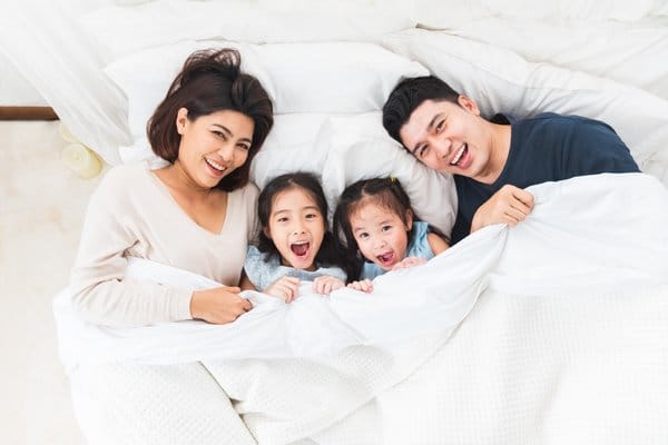 A happy family lying on the bed