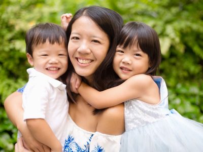 Happy Mother With Two Children A Photo of A Mother And Her Children Smiling