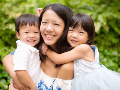 A Photo of A Mother And Her Children Smiling